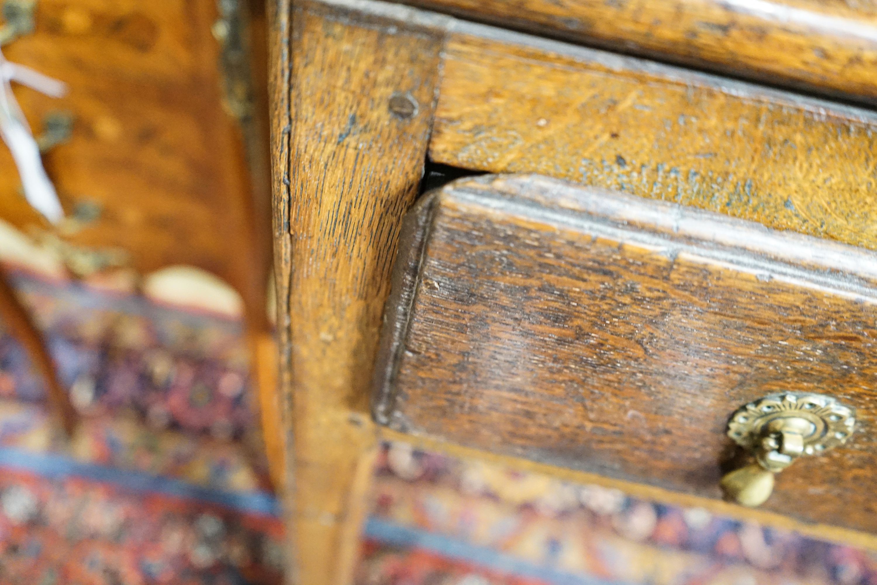 A George III oak dresser, with two shelf rack and three long drawers, on chamfered legs, width 167cm, depth 49cm, height 193cm